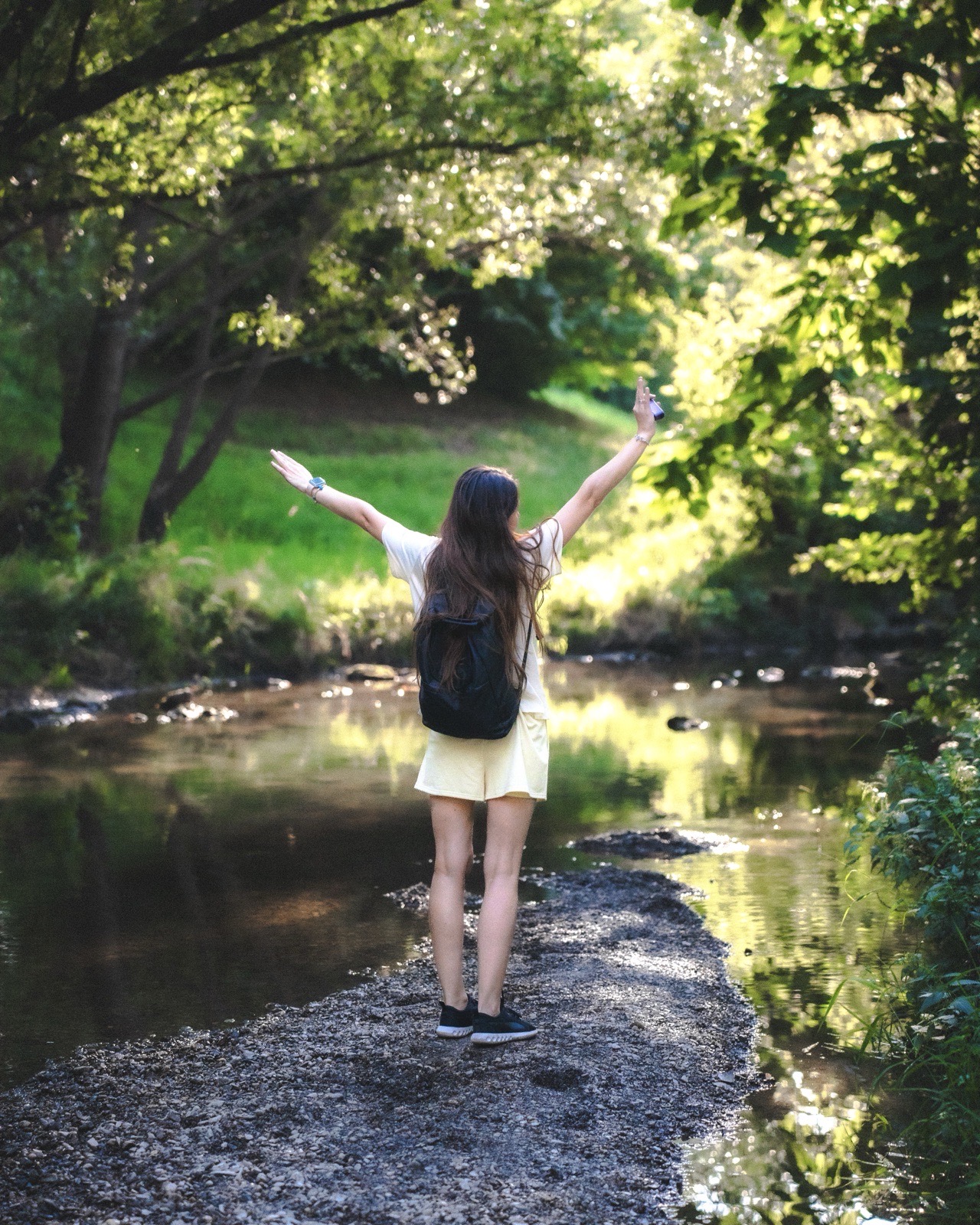 Girl by the stream, arms raised — Best Alex Shots, Vienna
