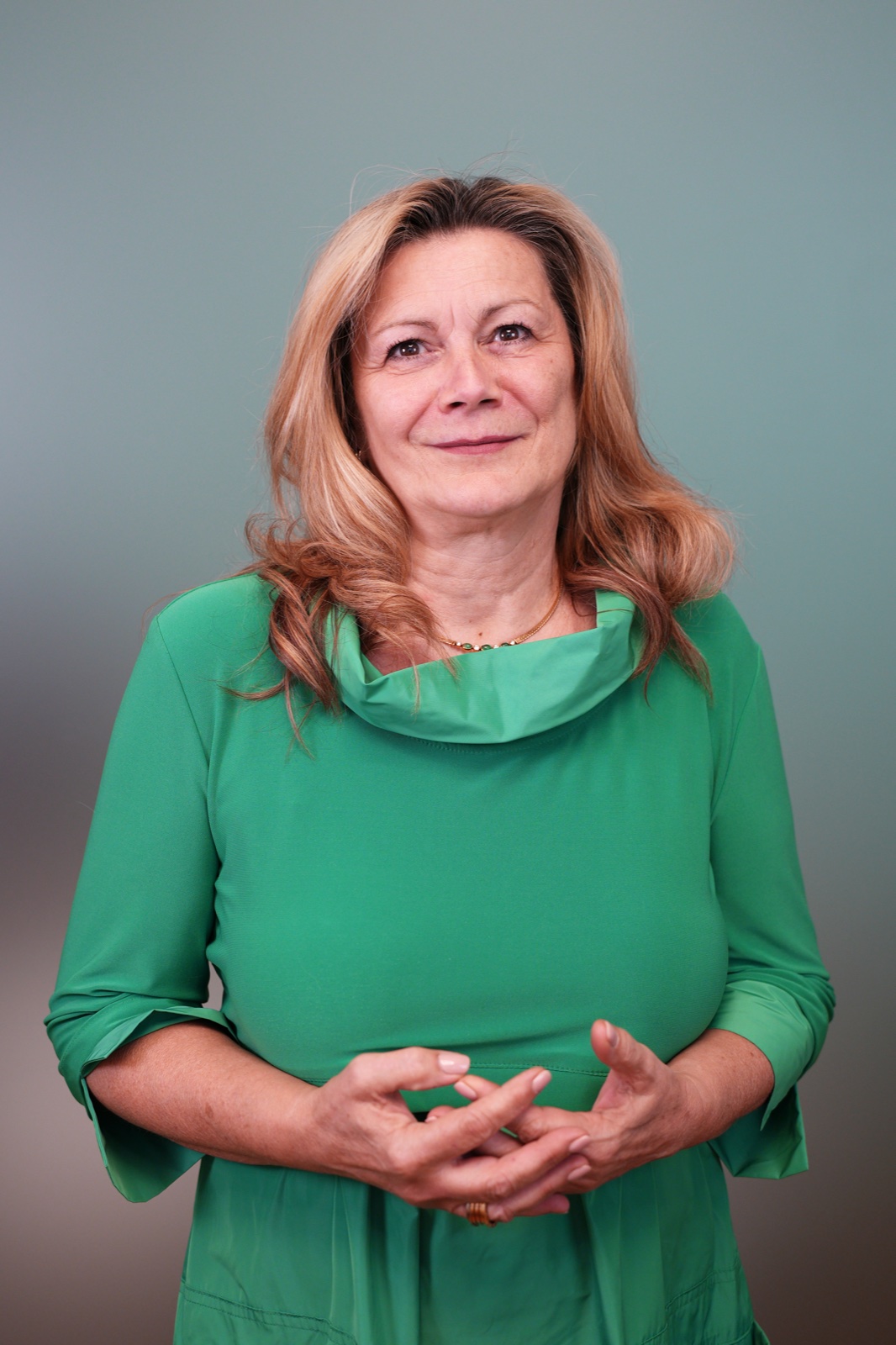 Smiling woman in green dress in studio — team corporate portrait by Best Alex Shots, Vienna