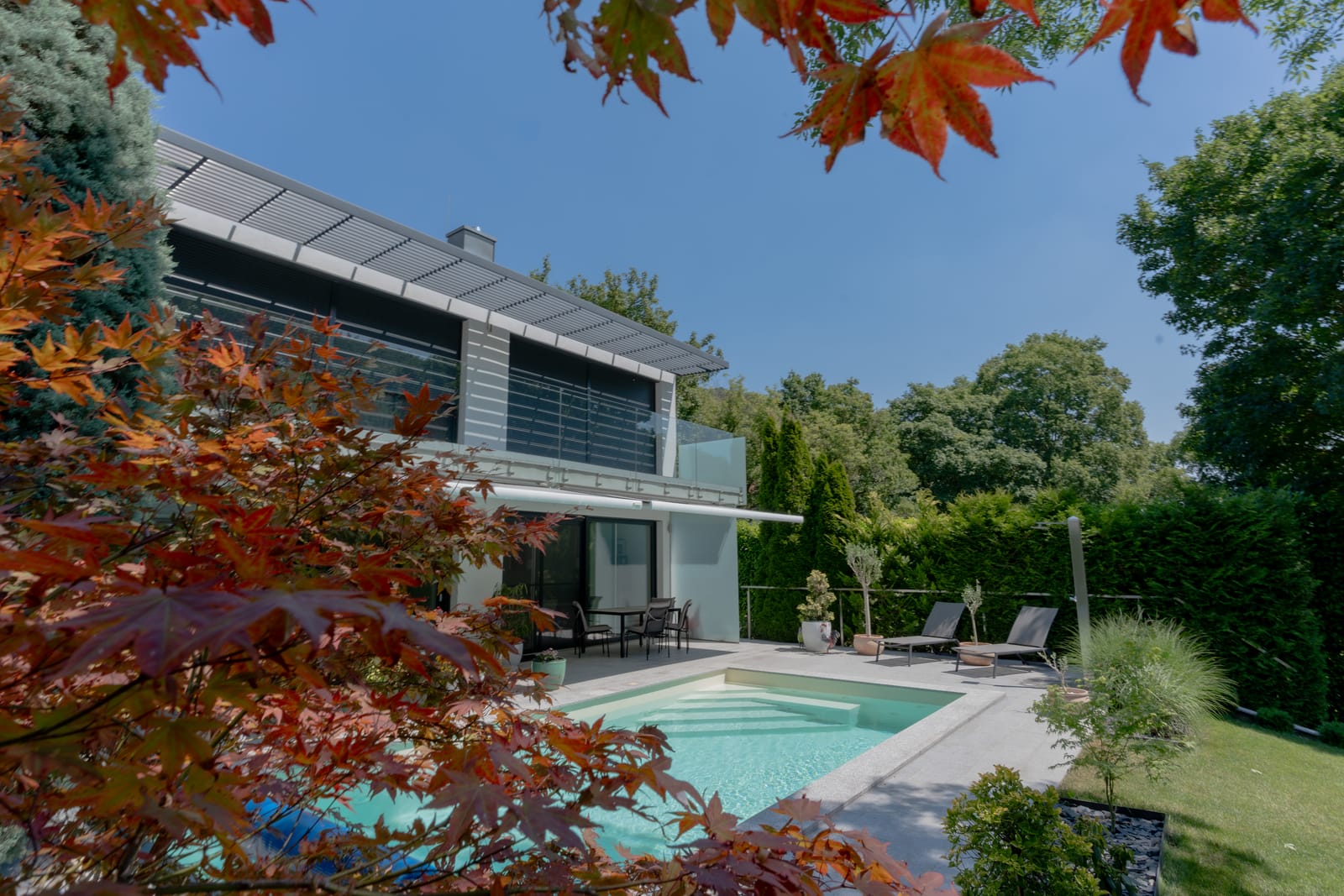 Modern villa with outdoor pool and landscaped garden framed by autumn maple, Vienna — Best Alex Shots real estate photography