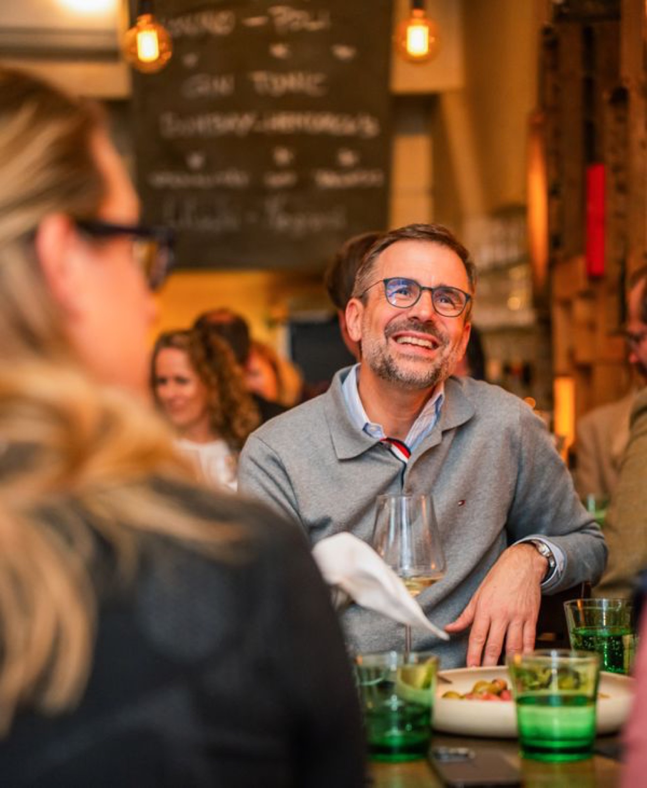 Smiling male guest at a wine bar dinner, Vienna — event photography by Best Alex Shots